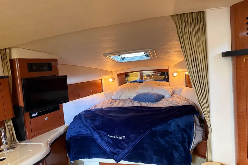 Slide: The Image of Luxurious interior of 2005 Sea Ray Sundancer 320 with cozy bed and TV. - 20