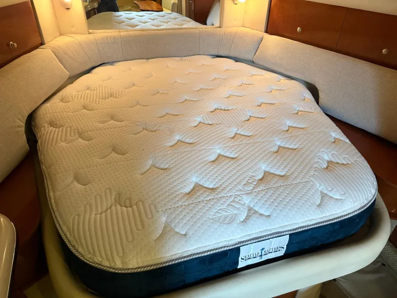 Slide: The Image of Interior of 2005 Sea Ray 320 Sundancer with a comfortable mattress in the cabin. - 22