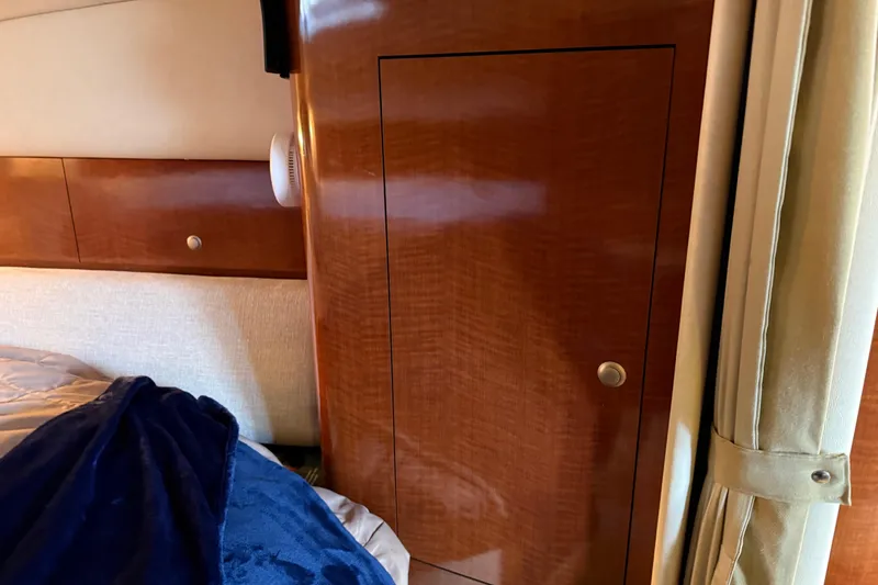 Slide: The Image of Interior cabin of 2005 Sea Ray Sundancer 320 with wooden cabinetry and cozy bedding. - 23