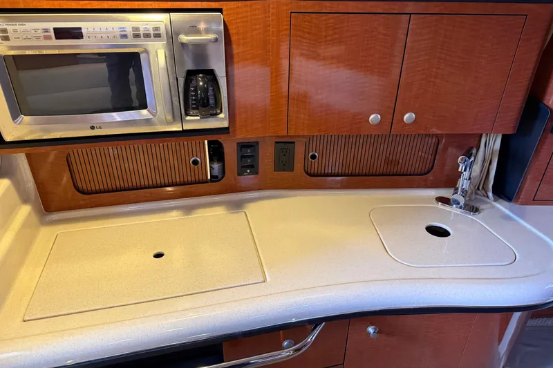 Slide: The Image of 2005 Sea Ray Sundancer 320 kitchen with microwave, coffee maker, and sink. - 27
