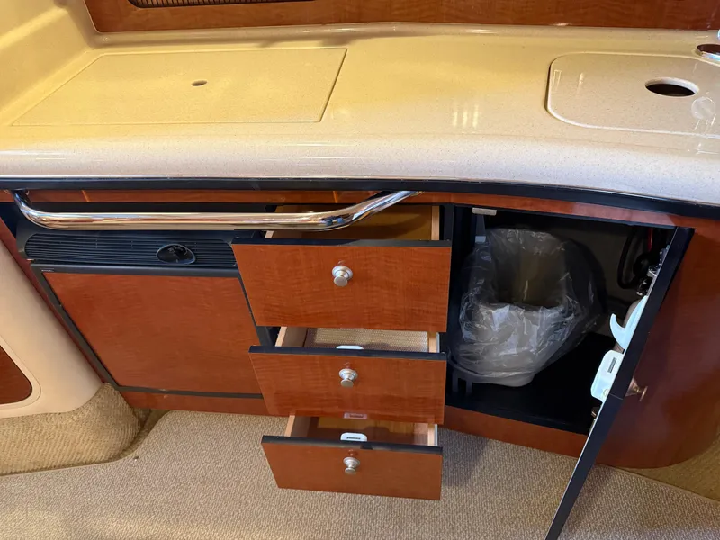 Slide: The Image of Interior view of 2005 Sea Ray 320 Sundancer with open drawers and cabinet. - 29
