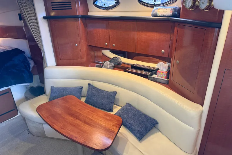 Slide: The Image of Interior of 2005 Sea Ray Sundancer 320 with wooden cabinetry and cushioned seating area. - 30