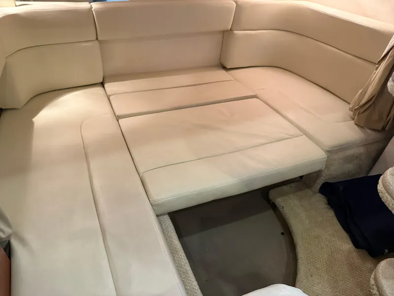 Slide: The Image of 2005 Sea Ray 320 Sundancer interior seating area with beige upholstery. - 33