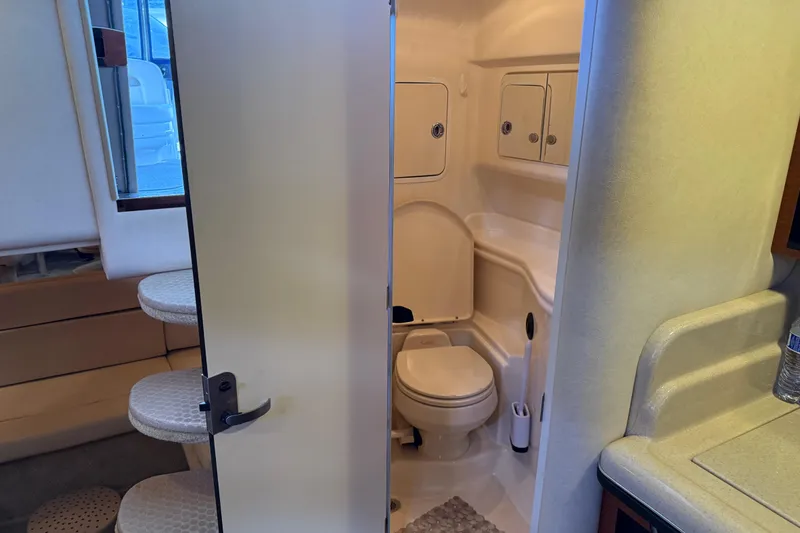Slide: The Image of 2005 Sea Ray Sundancer 320 interior bathroom with toilet and storage cabinets. - 35
