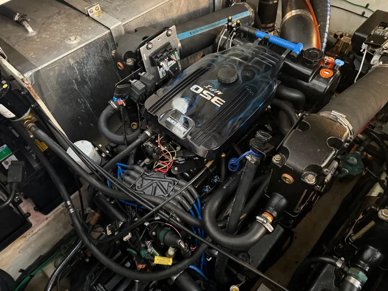 Slide: The Image of Engine compartment of a 2005 Sea Ray 320 Sundancer boat, showcasing detailed mechanical components. - 39