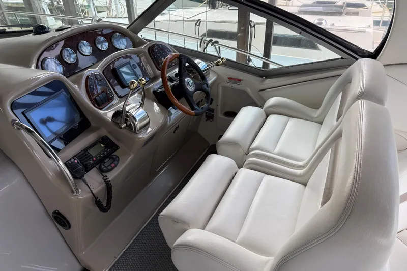 Slide: The Image of 2005 Sea Ray Sundancer 320 helm with dual seats and advanced navigation controls. - 4