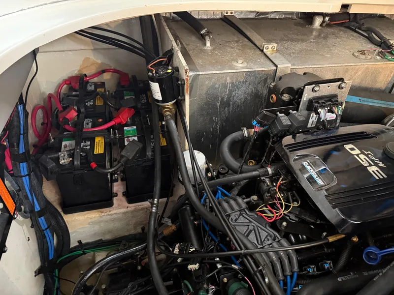 Slide: The Image of Engine compartment of a 2005 Sea Ray 320 Sundancer with visible batteries and wiring. - 42