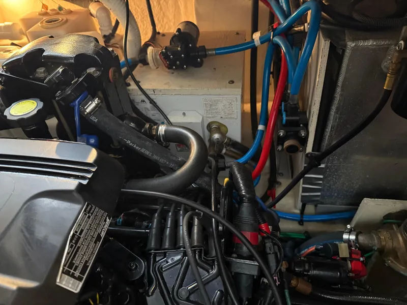 Slide: The Image of Engine compartment of a 2005 Sea Ray 320 Sundancer with visible hoses and components. - 43