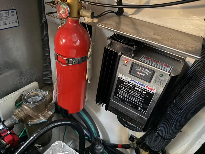 Slide: The Image of Engine compartment of 2005 Sea Ray 320 Sundancer with fire extinguisher and electrical components. - 44