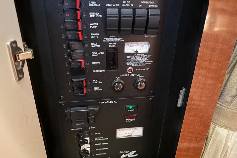 Slide: The Image of Control panel of a 2005 Sea Ray Sundancer 320 boat, showing switches and gauges. - 46