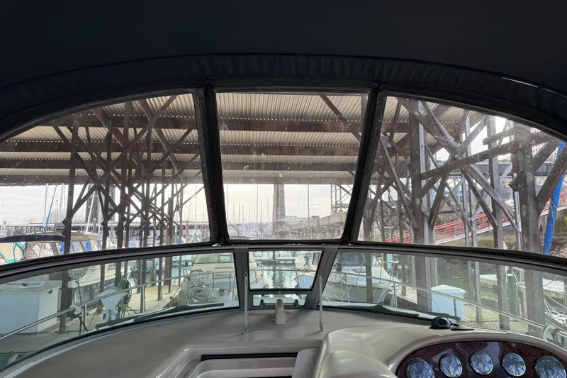 Slide: The Image of 2005 Sea Ray Sundancer 320 cockpit view under marina shelter. - 49