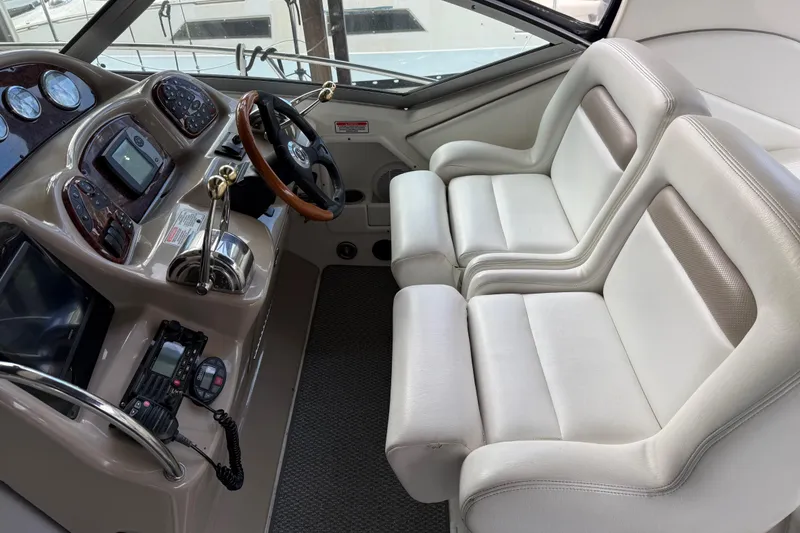 Slide: The Image of 2005 Sea Ray Sundancer 320 cockpit with dual seats and modern navigation controls. - 5