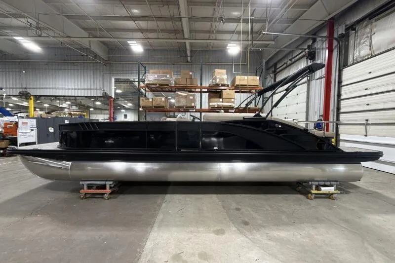Slide: The Image of 2026 Bennington 25 LTSBSF pontoon boat in a warehouse setting. - 1