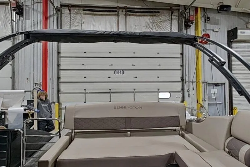 Slide: The Image of 2026 Bennington 25 LTSBSF boat interior in a warehouse setting. - 10