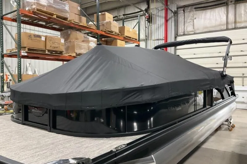 Slide: The Image of 2026 Bennington 25 LTSBSF pontoon boat with cover in a warehouse setting. - 21
