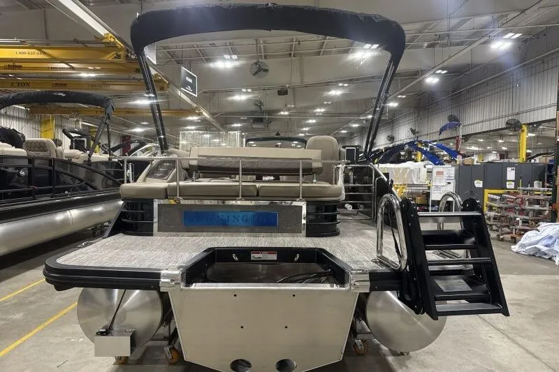 Slide: The Image of 2026 Bennington 25 LTSBSF pontoon boat in a factory setting, rear view. - 3