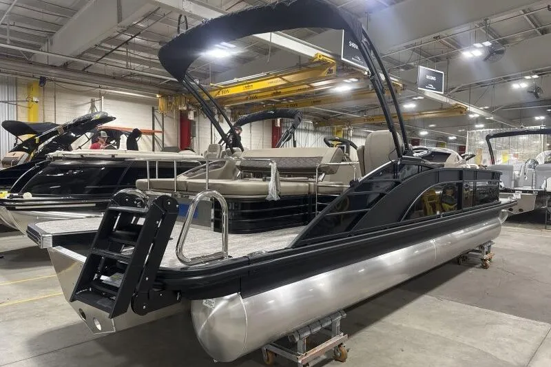 Slide: The Image of 2026 Bennington 25 LTSBSF pontoon boat in a showroom, showcasing sleek design and modern features. - 4