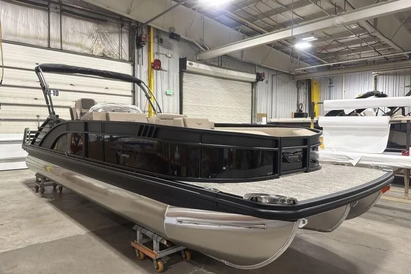 Slide: The Image of 2026 Bennington 25 LTSBSF pontoon boat in a warehouse setting. - 5