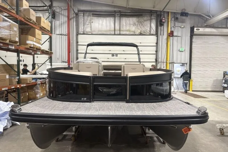 Slide: The Image of 2026 Bennington 25 LTSBSF pontoon boat in warehouse setting. - 6