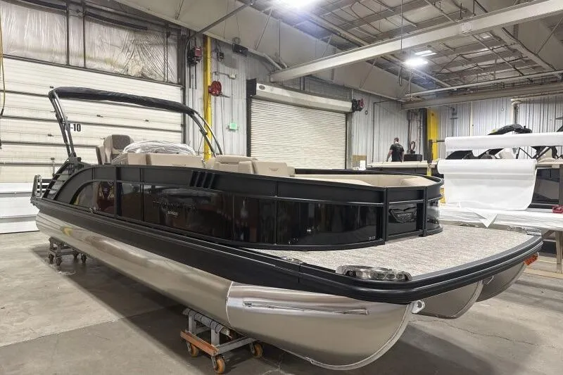 Slide: The Image of 2026 Bennington 25 LTSBSF pontoon boat in a warehouse setting. - 9