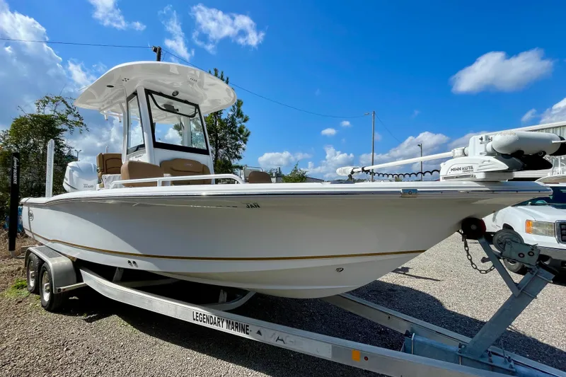 Slide: The Image of 2021 Sea Hunt BX 25 FS boat on trailer under clear blue sky. - 10