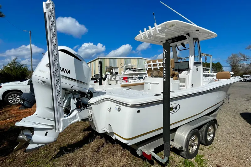 Slide: The Image of 2021 Sea Hunt BX 25 FS boat with Yamaha engine on trailer, outdoors under blue sky. - 11