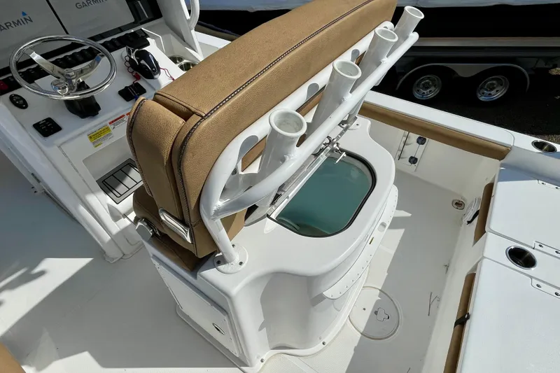 Slide: The Image of 2021 Sea Hunt BX 25 FS boat interior with helm, rod holders, and livewell. - 12