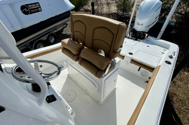 Slide: The Image of 2021 Sea Hunt BX 25 FS boat interior with tan seating and steering wheel. - 13