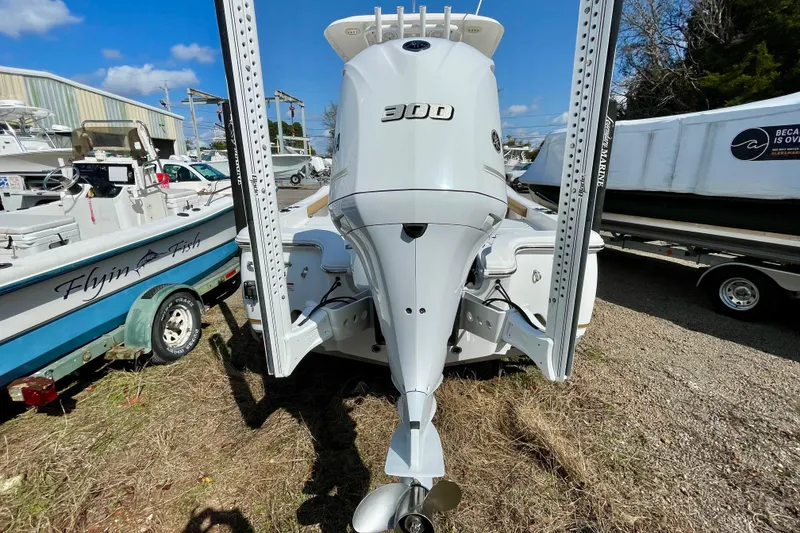 Slide: The Image of 2021 Sea Hunt BX 25 FS boat with powerful 300 engine, parked outdoors. - 14