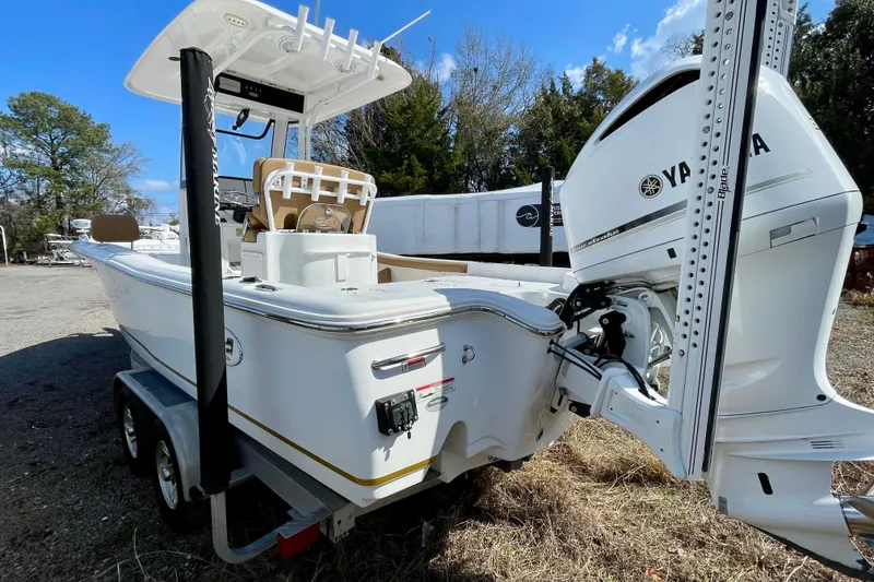 Slide: The Image of 2021 Sea Hunt BX 25 FS boat with Yamaha engine on trailer, parked outdoors. - 15