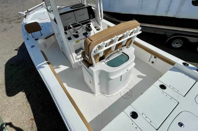 Slide: The Image of 2021 Sea Hunt BX 25 FS boat interior with helm, seating, and storage compartments. - 16