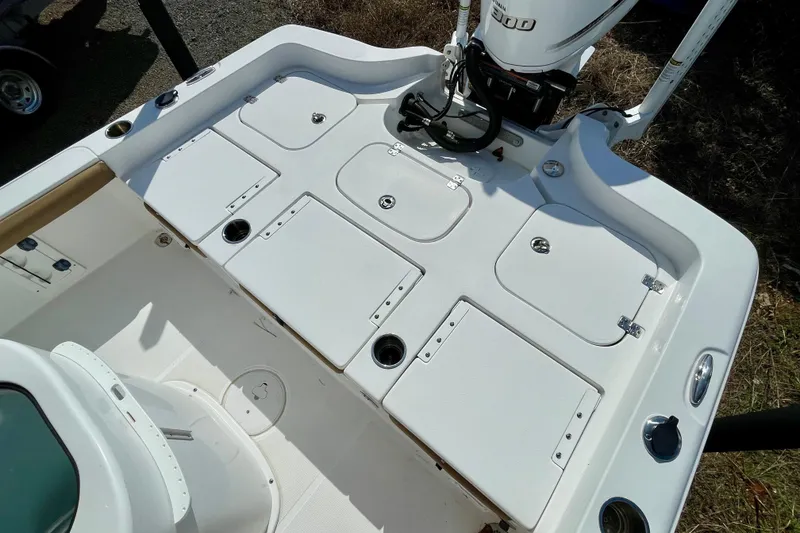 Slide: The Image of 2021 Sea Hunt BX 25 FS boat deck with storage compartments and Yamaha engine. - 17