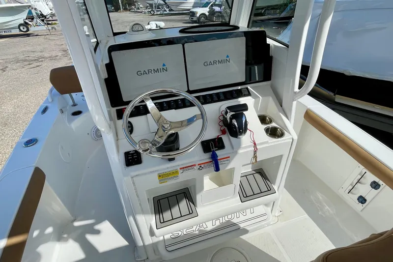 Slide: The Image of 2021 Sea Hunt BX 25 FS boat console with Garmin displays and steering wheel. - 18