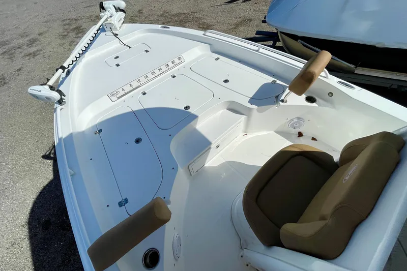 Slide: The Image of 2021 Sea Hunt BX 25 FS boat interior with seating and fishing rod holders. - 19