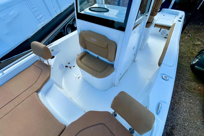 Slide: The Image of 2021 Sea Hunt BX 25 FS boat interior with tan seating and white deck. - 22