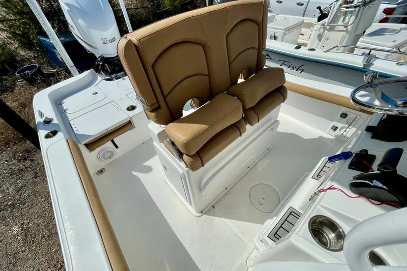 Slide: The Image of 2021 Sea Hunt BX 25 FS boat interior with tan seating and steering console. - 26