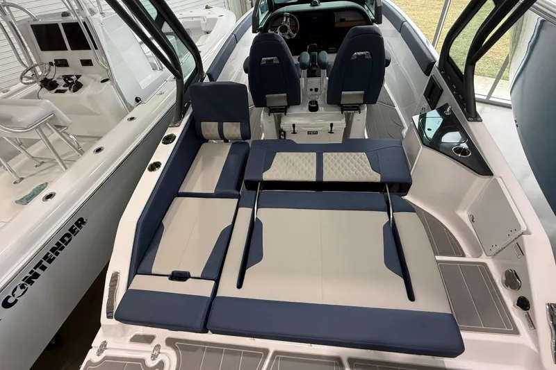 Slide: The Image of 2026 Monterey Elite 25 OB boat interior with blue and white seating and modern dashboard. - 10