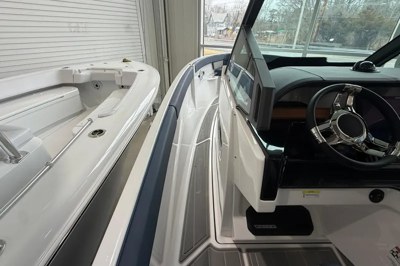Slide: The Image of 2026 Monterey Elite 25 OB boat interior with sleek dashboard and steering wheel. - 8