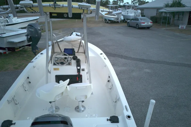 Slide: The Image of 2014 Key West 176 Bay Reef boat with Yamaha engine, parked outdoors. - 12