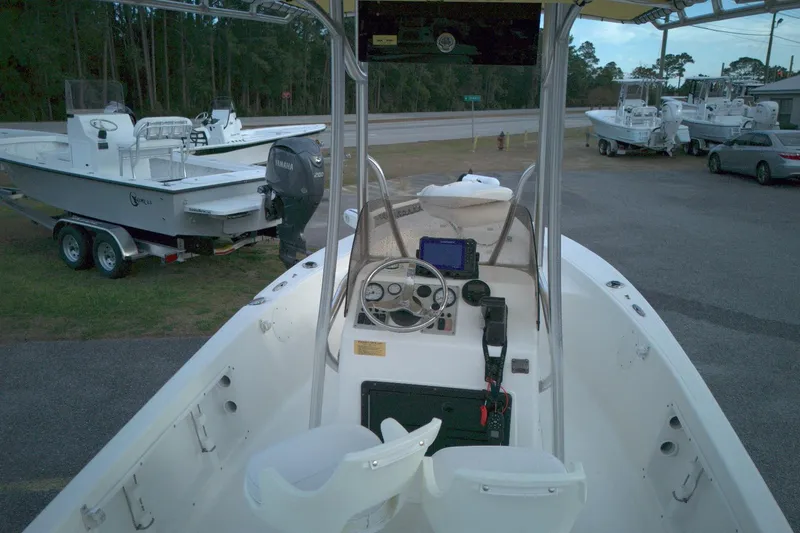 Slide: The Image of 2014 Key West 176 Bay Reef boat with Yamaha engine, parked near other boats. - 5