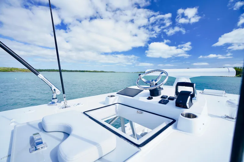 Slide: The Image of 2023 SeaHunter 41 CTS boat helm with ocean view under blue sky. - 15