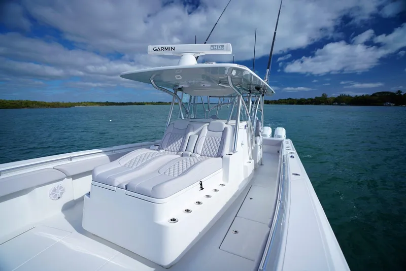 Slide: The Image of 2023 SeaHunter 41 CTS boat on calm water, featuring sleek design and modern amenities. - 13