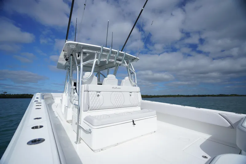 Slide: The Image of 2023 SeaHunter 41 CTS boat with sleek design, spacious deck, and fishing rods under a blue sky. - 7