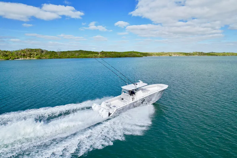 Slide: The Image of 2023 SeaHunter 41 CTS cruising on a clear blue lake under a partly cloudy sky. - 20