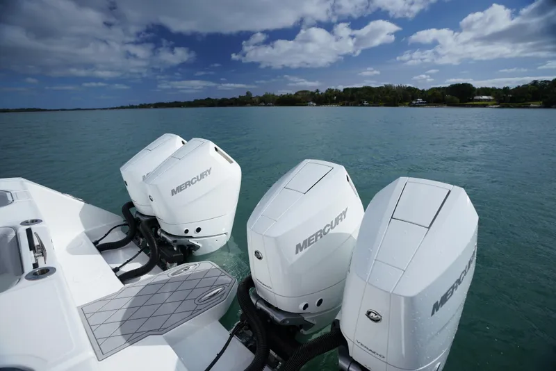 Slide: The Image of 2023 SeaHunter 41 CTS boat with four Mercury outboard engines on a calm sea. - 10