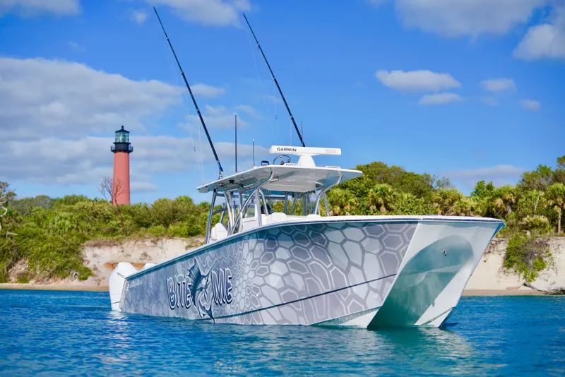 The Image of 2023 SeaHunter 41 CTS boat on water near lighthouse, clear sky. - 0