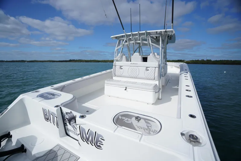 Slide: The Image of 2023 SeaHunter 41 CTS boat on water, featuring spacious deck and seating. - 9