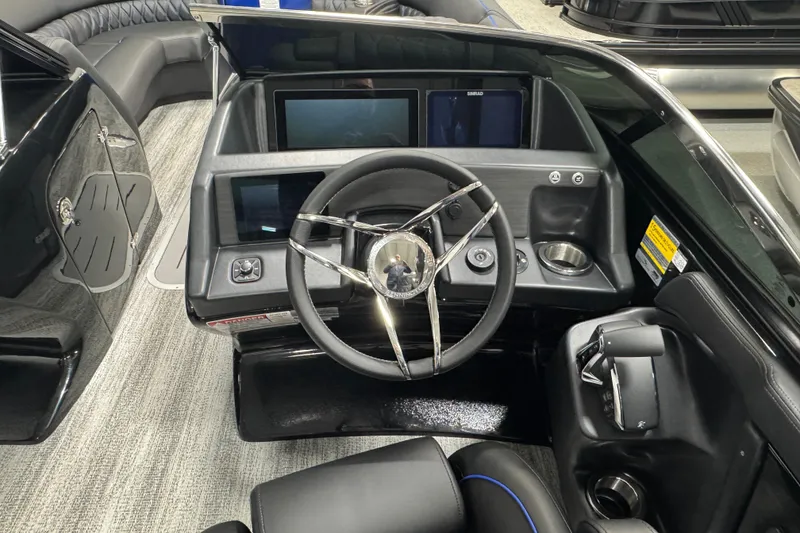 Slide: The Image of 2026 Bennington 25 QSBWASE boat dashboard with modern steering and digital displays. - 10