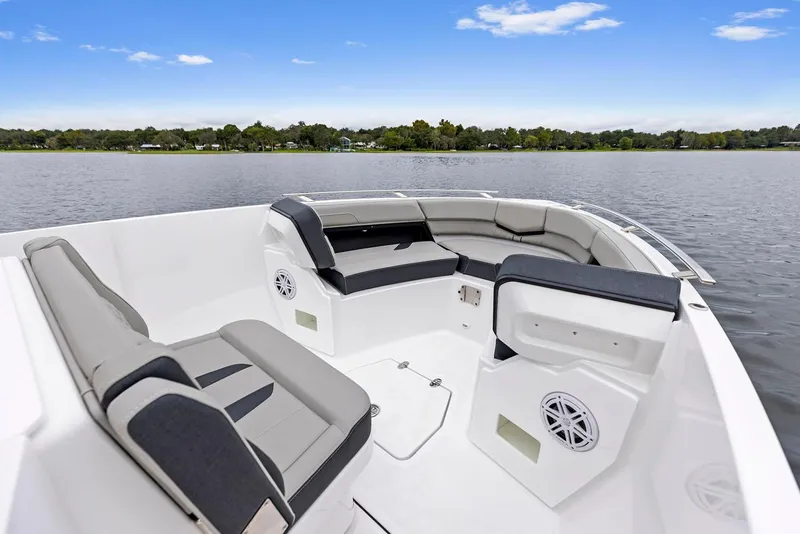 Slide: The Image of Manufacturer Provided Image: 2026 Monterey Elite 27 OB boat interior with spacious seating on a calm lake. - 1