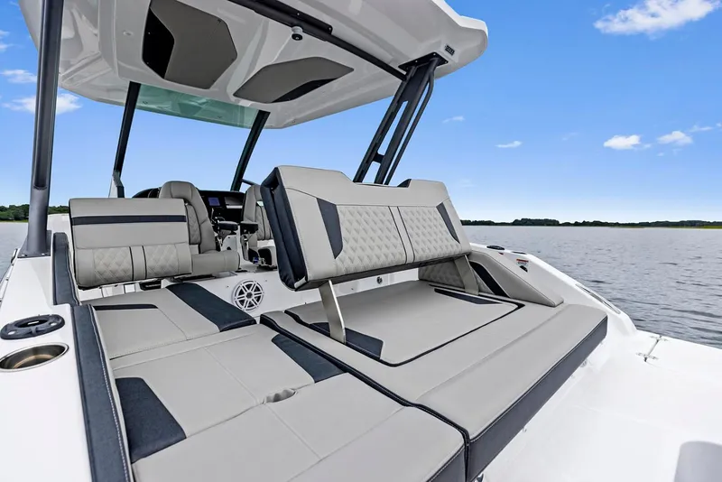 Slide: The Image of Manufacturer Provided Image: 2026 Monterey Elite 27 OB boat interior with luxurious seating on a calm lake. - 6